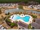 Overhead image of a community pool and amenity center with views of the pond and residential homes at 323 Waterlily Way, Summerville, SC 29486