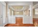 Elegant dining room showcasing hardwood floors, a tray ceiling, and bright windows with shutters at 323 Waterlily Way, Summerville, SC 29486