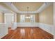 Bright dining room with hardwood floors, large windows, and a classic chandelier for stylish meals at 323 Waterlily Way, Summerville, SC 29486
