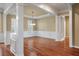 Stylish dining room features hardwood floors, wainscoting, decorative columns, and a modern light fixture at 323 Waterlily Way, Summerville, SC 29486