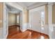 Charming foyer with hardwood floors, front door, and French doors leading to a room with natural light at 323 Waterlily Way, Summerville, SC 29486