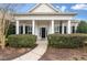 Inviting front porch with classic columns and manicured landscaping at 323 Waterlily Way, Summerville, SC 29486