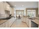 Well-lit kitchen boasts tile floors, granite countertops, and modern appliances at 323 Waterlily Way, Summerville, SC 29486