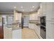 Spacious kitchen with granite countertops, white cabinetry, and tile floors at 323 Waterlily Way, Summerville, SC 29486