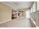 Open-concept living room with tiled floor, leading to the kitchen and outdoor access at 323 Waterlily Way, Summerville, SC 29486