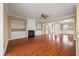 Open-concept living room with fireplace, built-in shelves, and hardwood floors at 323 Waterlily Way, Summerville, SC 29486