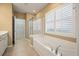 Serene bathroom featuring tiled floor, shower, bathtub, and natural light, creating a relaxing atmosphere at 323 Waterlily Way, Summerville, SC 29486