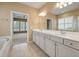 Spacious main bathroom with a double vanity, ample lighting, and a glimpse into the shower area at 323 Waterlily Way, Summerville, SC 29486