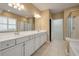 Elegant main bathroom featuring double sink vanity, tiled floors, and a well-lit mirror at 323 Waterlily Way, Summerville, SC 29486