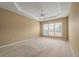 Spacious main bedroom with carpet, tray ceiling and several windows with shutters allowing for ample sunlight at 323 Waterlily Way, Summerville, SC 29486