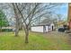 A detached garage in backyard with a covered area to the side and lots of trees at 3351 Londonderry Rd, North Charleston, SC 29420