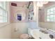 A vintage style bathroom with toilet, sink and mirror at 3351 Londonderry Rd, North Charleston, SC 29420