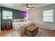 A modern bedroom with unique dark paneling wall, ceiling fan and hardwood floors at 3351 Londonderry Rd, North Charleston, SC 29420