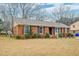 Traditional brick home with lush landscaping, a well-maintained yard, and inviting curb appeal at 3351 Londonderry Rd, North Charleston, SC 29420