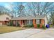 Charming brick home with a well-manicured lawn and a long driveway with mature trees at 3351 Londonderry Rd, North Charleston, SC 29420