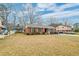 A charming, single-story brick home with a well-manicured lawn and blue sky at 3351 Londonderry Rd, North Charleston, SC 29420