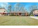 Classic brick home featuring black shutters, landscaping, and a well-manicured front lawn at 3351 Londonderry Rd, North Charleston, SC 29420