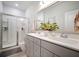 Bright bathroom featuring double sinks, a large mirror, and a glass-enclosed shower at 352 Great Lawn Dr, Summerville, SC 29486