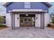 Inviting clubhouse entrance featuring beautiful wood doors and stone walkway at 352 Great Lawn Dr, Summerville, SC 29486