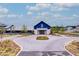 Exterior view of the community clubhouse, showcasing beautiful landscaping and hardscapes at 352 Great Lawn Dr, Summerville, SC 29486