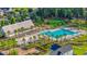 Beautiful aerial view of a community pool with palm trees, lounge chairs, a covered pavilion and playground at 352 Great Lawn Dr, Summerville, SC 29486