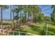 A fenced dog park featuring agility tunnels, benches, and green grass, set amidst towering pine trees at 352 Great Lawn Dr, Summerville, SC 29486