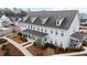 Exterior elevation showing a three-story townhome with a covered front porch at 352 Great Lawn Dr, Summerville, SC 29486