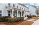 Inviting front porch featuring a seating area and well-maintained landscaping at 352 Great Lawn Dr, Summerville, SC 29486