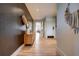 Hallway with wood accent wall leading to gym with modern furnishings at 352 Great Lawn Dr, Summerville, SC 29486