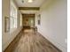Hallway with wood-look floors, decorative wall hangings, and accent beams at 352 Great Lawn Dr, Summerville, SC 29486