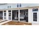 Cozy screened porch features white furniture and bike storage at 352 Great Lawn Dr, Summerville, SC 29486