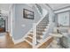 Elegant staircase with wood treads, black iron balusters, and bright, natural light at 3736 Goodwater St, Mount Pleasant, SC 29466