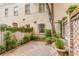 Quaint backyard with brick pavers, lush greenery, and a charming water feature at 38 Elliott St, Charleston, SC 29401