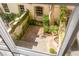 Overhead view of a private backyard with brick patio and lush landscaping at 38 Elliott St, Charleston, SC 29401
