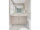 Stylish bathroom with a vanity, granite countertop, and a large mirror reflecting glass shower at 38 Elliott St, Charleston, SC 29401