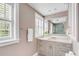 Bright bathroom with a granite vanity top, and large mirror reflecting a glass shower at 38 Elliott St, Charleston, SC 29401