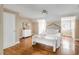 Cozy bedroom with a large bed, white dresser, and hardwood flooring at 38 Elliott St, Charleston, SC 29401