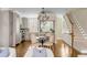 Open-concept dining area with modern lighting, seamlessly connecting to the kitchen and staircase at 38 Elliott St, Charleston, SC 29401