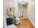 Inviting home entryway featuring hardwood floors, staircase, elegant chandelier, and stylish furnishings at 38 Elliott St, Charleston, SC 29401