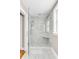 Modern bathroom showcasing a glass-enclosed shower with marble tile and a built-in bench at 38 Elliott St, Charleston, SC 29401