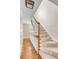 Carpeted staircase with white spindles and a wooden handrail, leading to the upper level at 38 Elliott St, Charleston, SC 29401