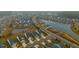Aerial view of a scenic residential neighborhood with ponds and streets lined by palm trees at 402 Switchgrass Dr, Summerville, SC 29486