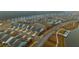 A birds eye view of a residential community highlighting a network of roads, ponds, and meticulously arranged houses at 402 Switchgrass Dr, Summerville, SC 29486