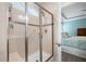 Beautiful bathroom featuring tiled shower with glass door and seat, with view to bedroom at 402 Switchgrass Dr, Summerville, SC 29486