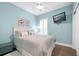 Bedroom featuring a light blue accent wall, dark floors, TV, and white furniture at 402 Switchgrass Dr, Summerville, SC 29486