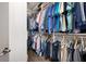 Walk-in closet featuring wooden floors, white shelving, and racks filled with clothing at 402 Switchgrass Dr, Summerville, SC 29486