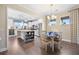 Open dining area adjacent to a modern kitchen with stainless steel appliances and an island, perfect for Gathering meals at 402 Switchgrass Dr, Summerville, SC 29486
