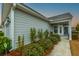 Charming home featuring a welcoming front entrance, a beautiful door, and lush landscaping at 402 Switchgrass Dr, Summerville, SC 29486