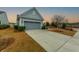 Charming home featuring a two-car garage and well manicured front yard with tasteful shrubs at 402 Switchgrass Dr, Summerville, SC 29486