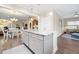 Open-concept kitchen featuring white cabinets, marble countertops and an adjacent living area at 402 Switchgrass Dr, Summerville, SC 29486